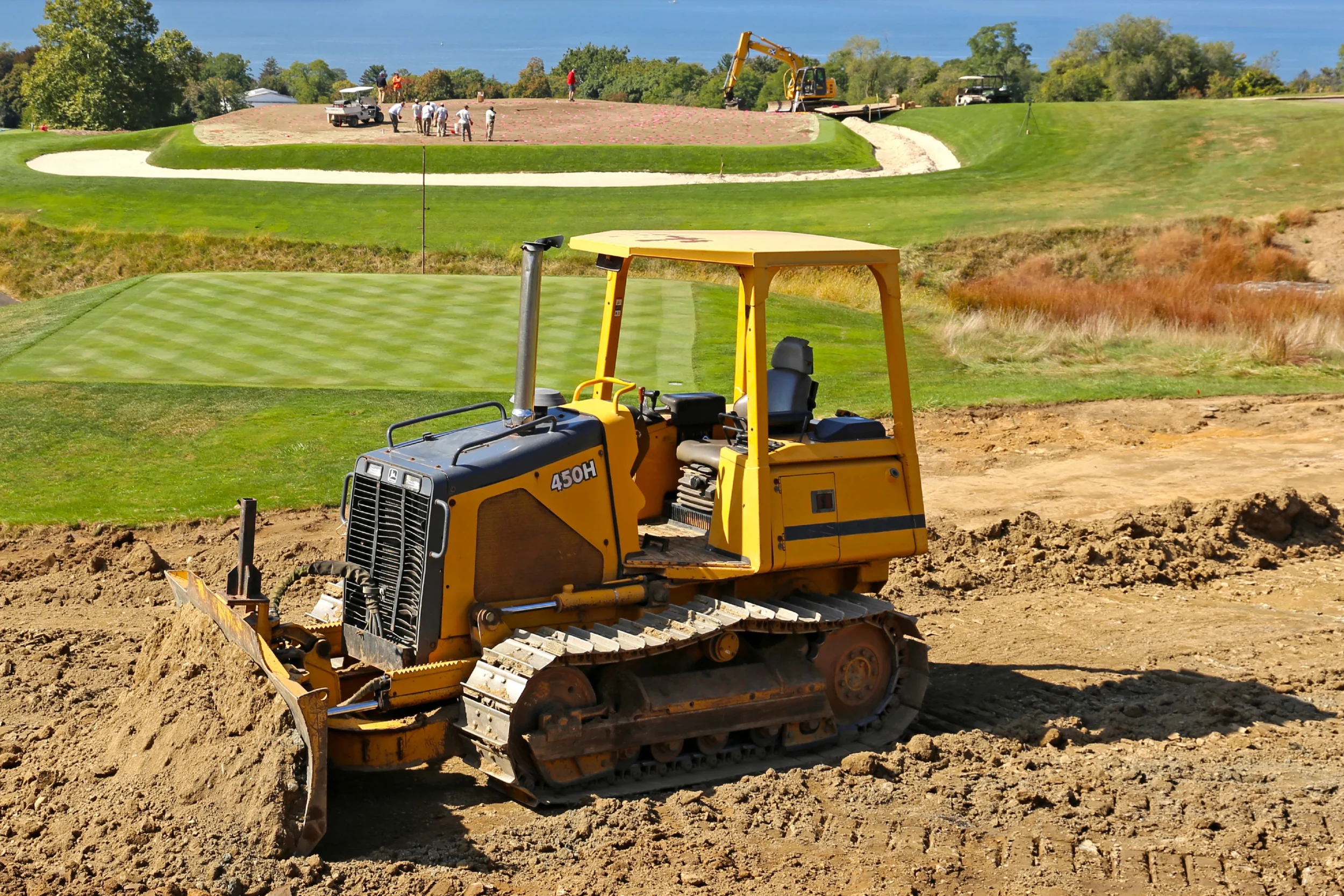 Bulldozer on golf course construction site with renovation work in progress
